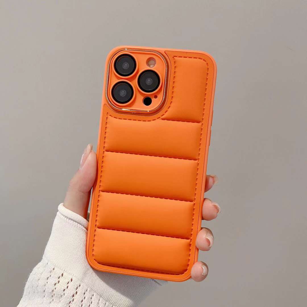 Orange phone case held by a hand against a neutral background